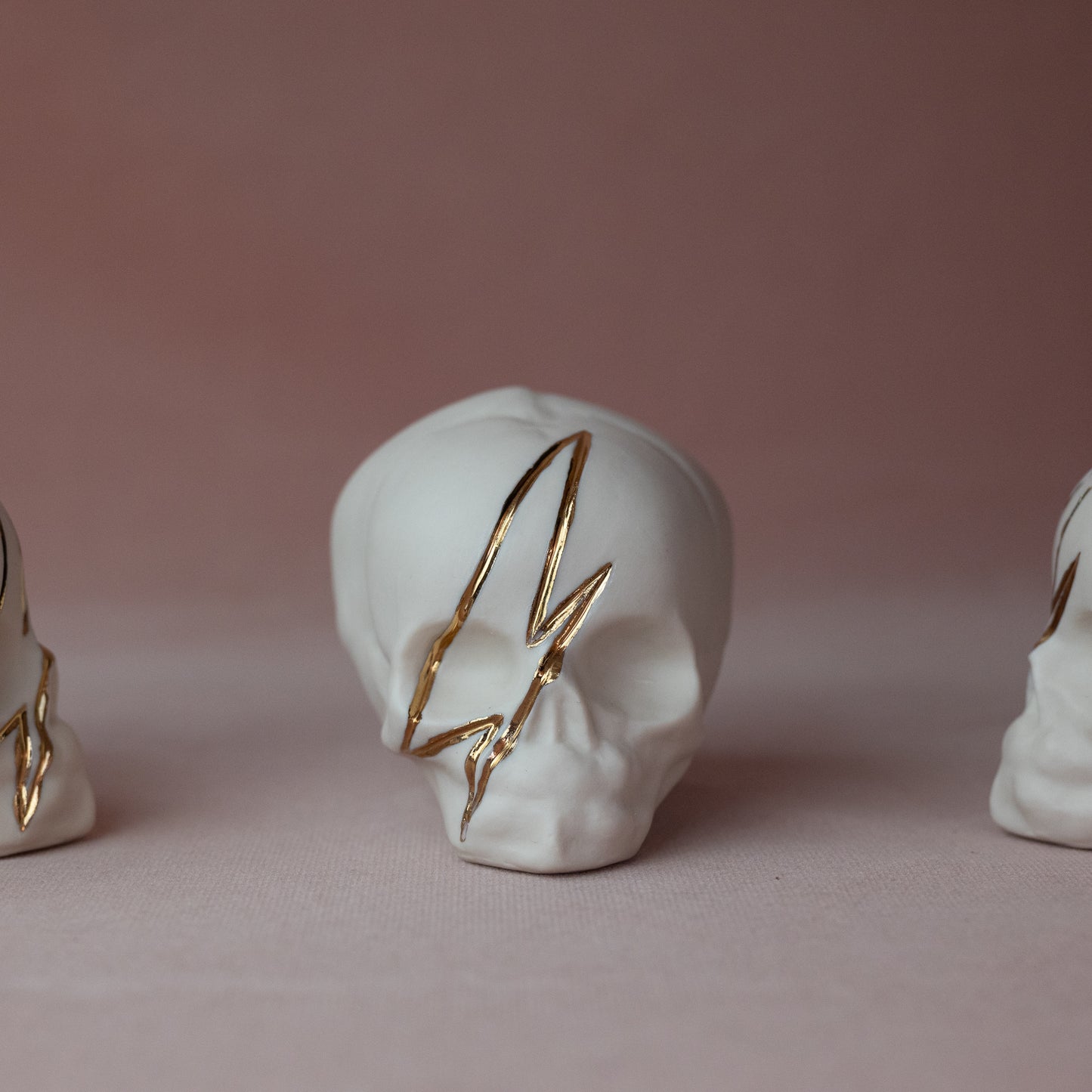 Gilded Porcelain Skull with Lighting Bolt