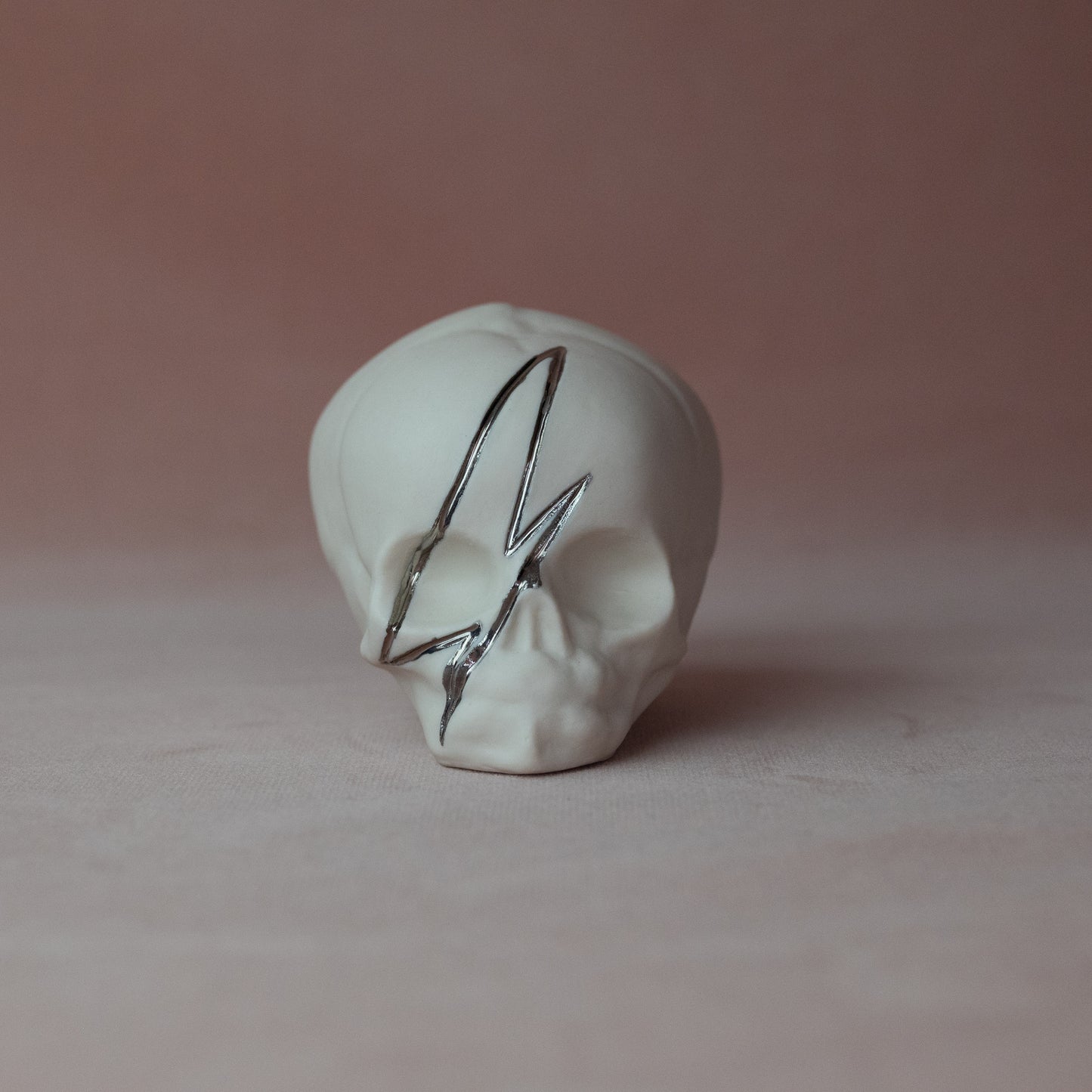 Gilded Porcelain Skull with Lighting Bolt