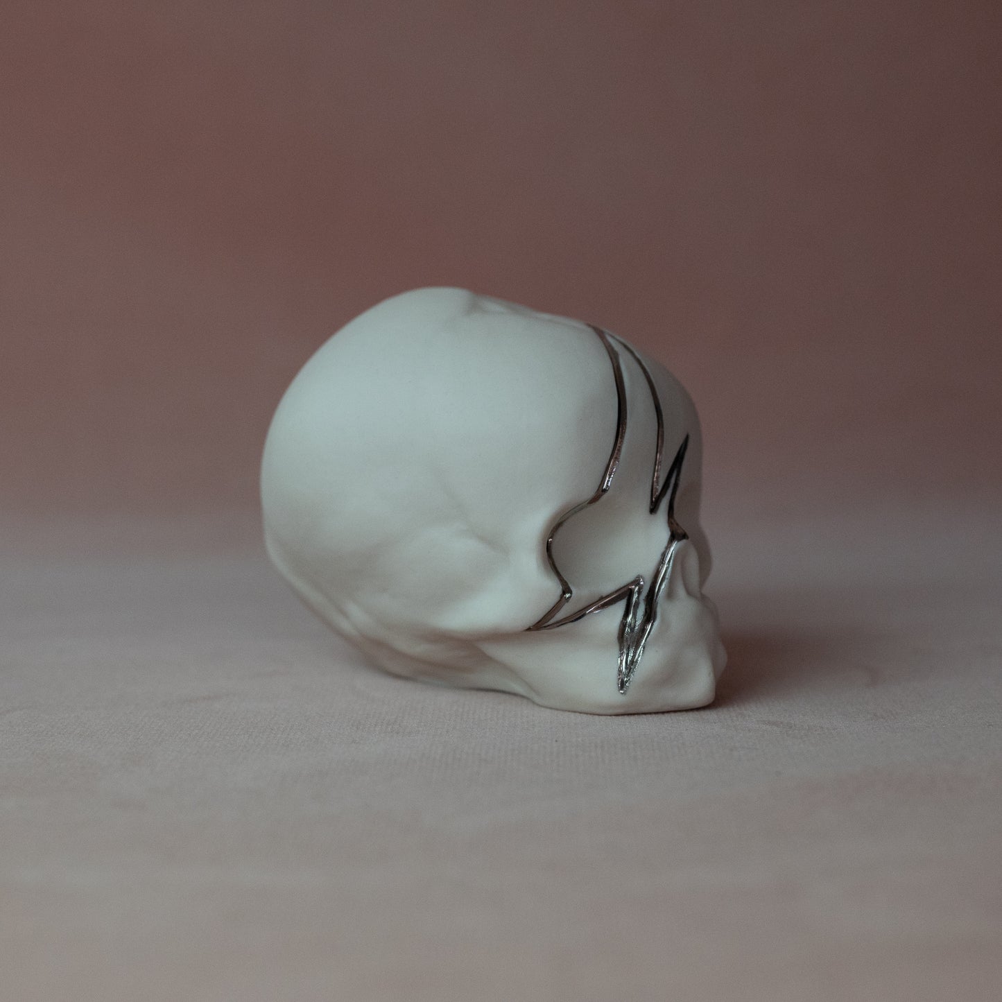 Gilded Porcelain Skull with Lighting Bolt