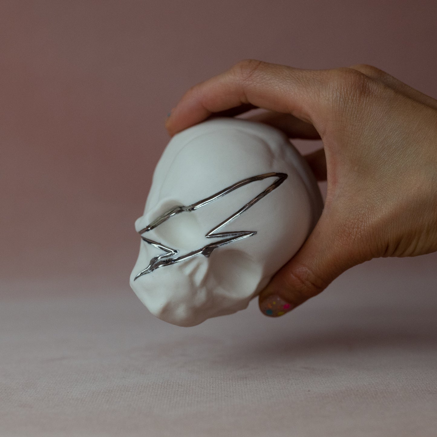 Gilded Porcelain Skull with Lighting Bolt