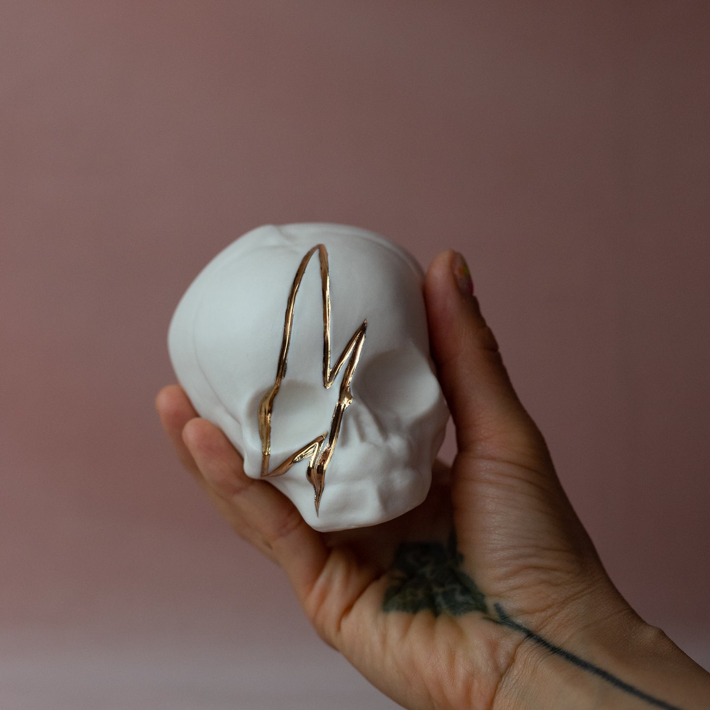 Gilded Porcelain Skull with Lighting Bolt