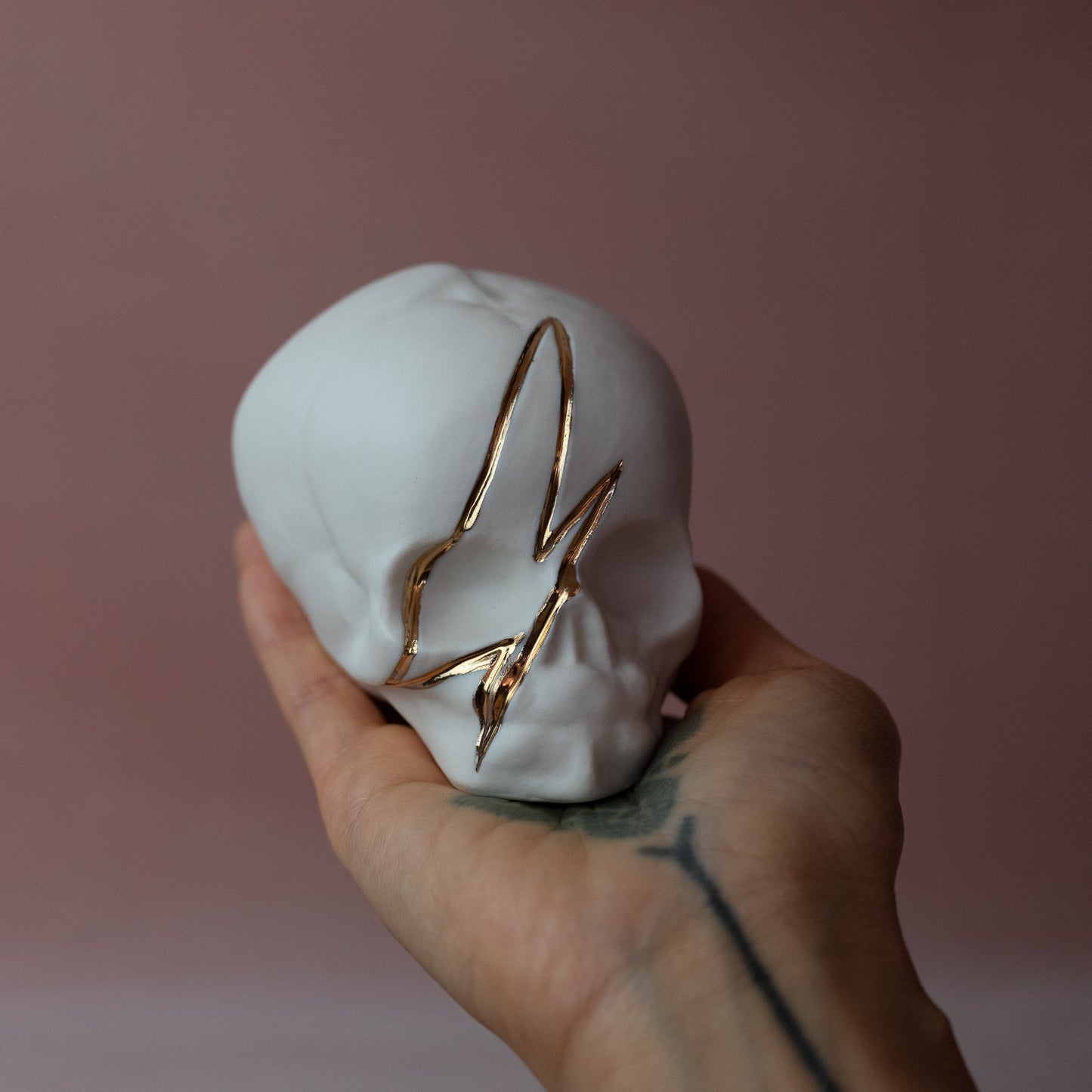 Gilded Porcelain Skull with Lighting Bolt