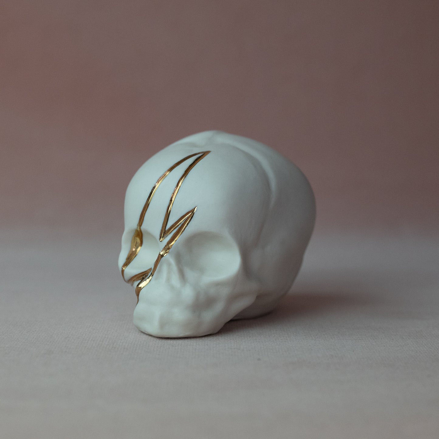 Gilded Porcelain Skull with Lighting Bolt